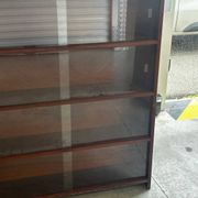 Vintage 1960s wooden library with sliding doors.