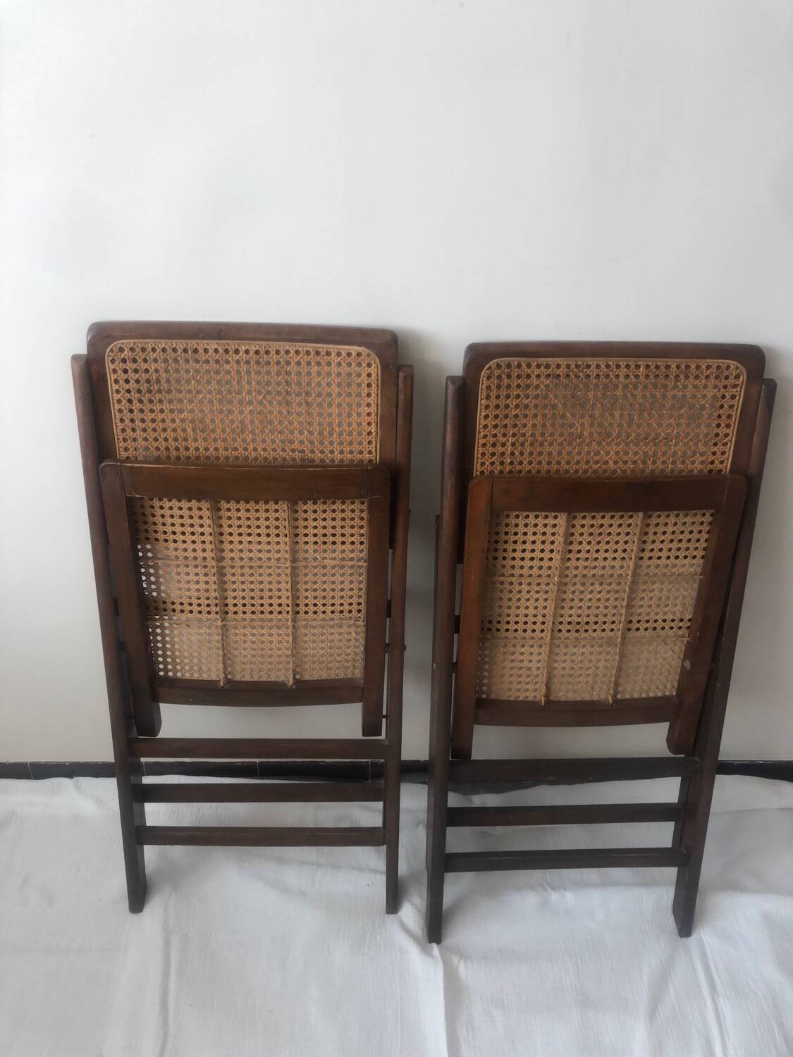 Pair of folding chairs in cane and dark wood