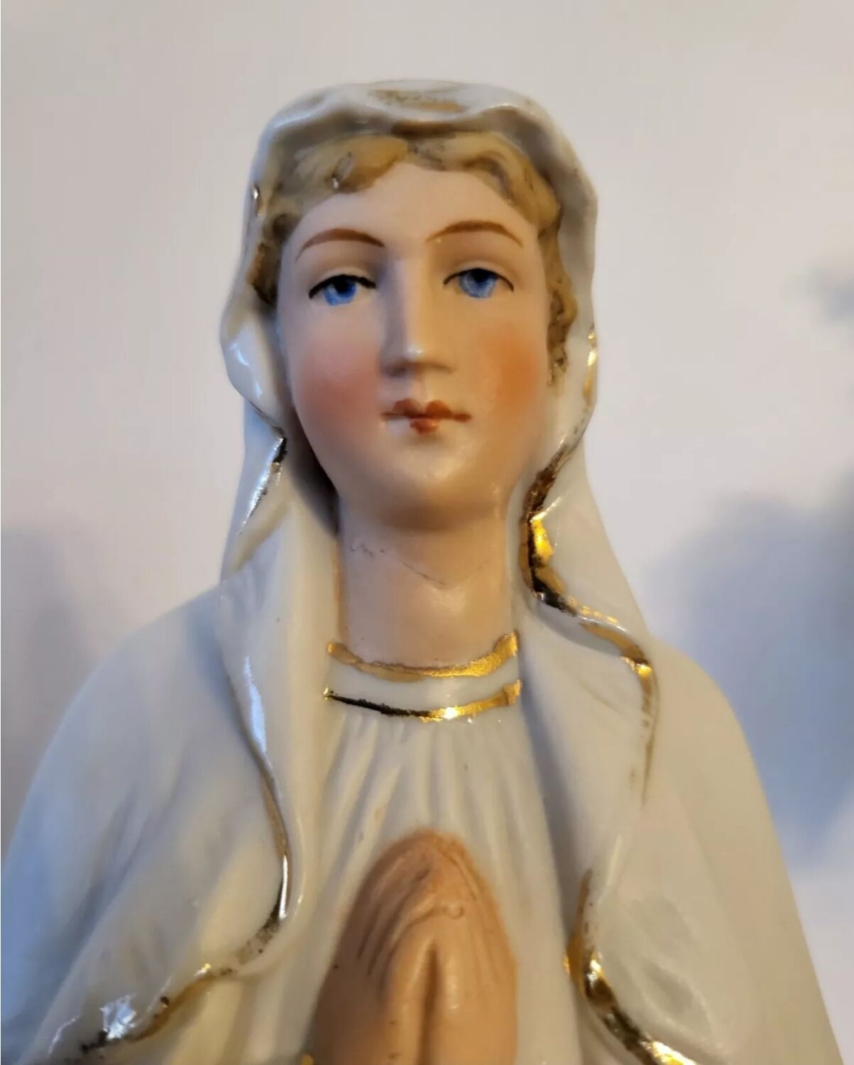 Religious statuette of the Virgin Mary in bisque porcelain