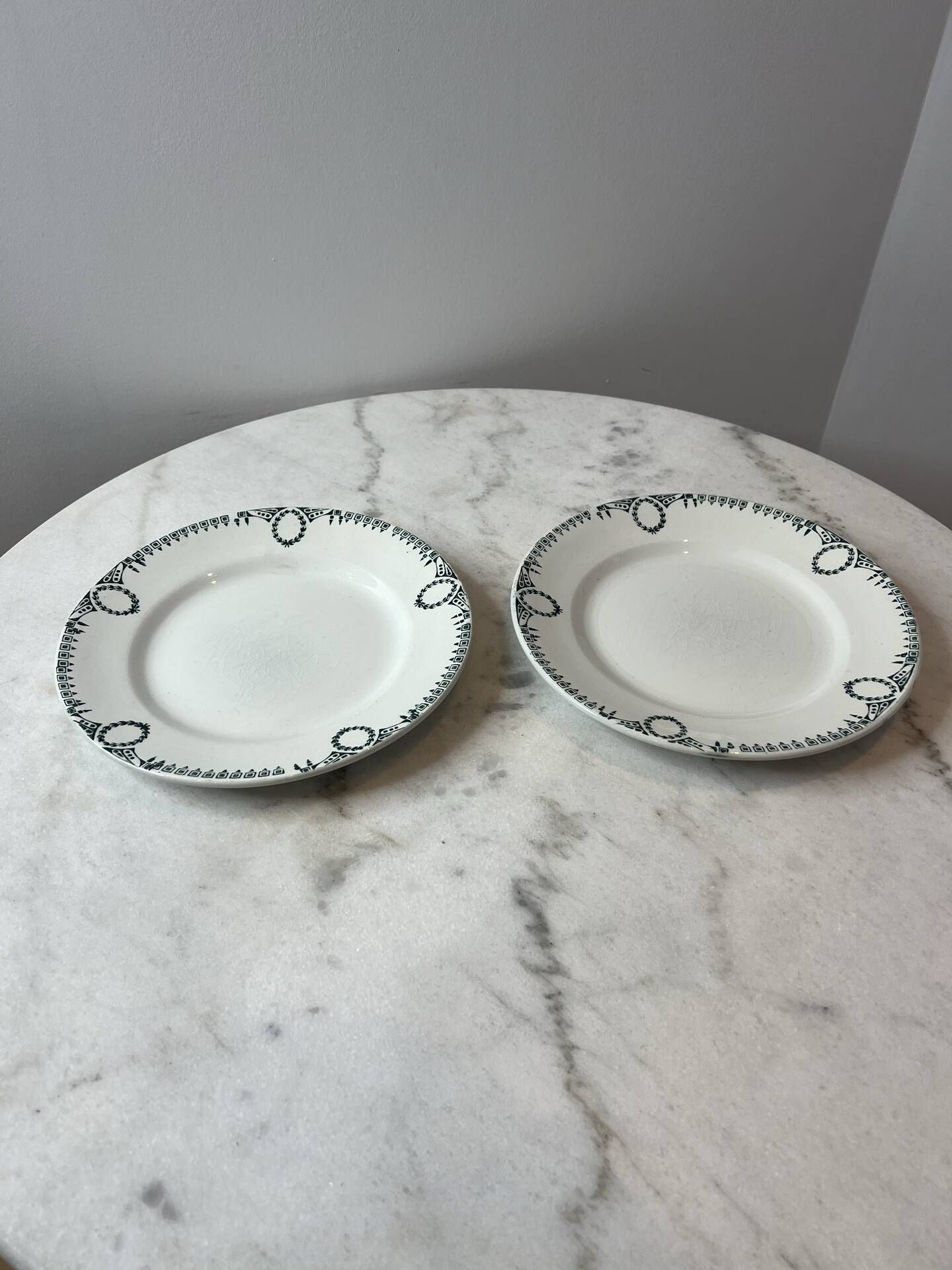 Set of 2 Saint Amand plates with laurel crown decoration.