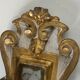 Pair of wall sconces in carved wood and silvered and gilded patinated metal with a central mirror.