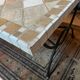 Beige ceramic coffee table with black metal legs.