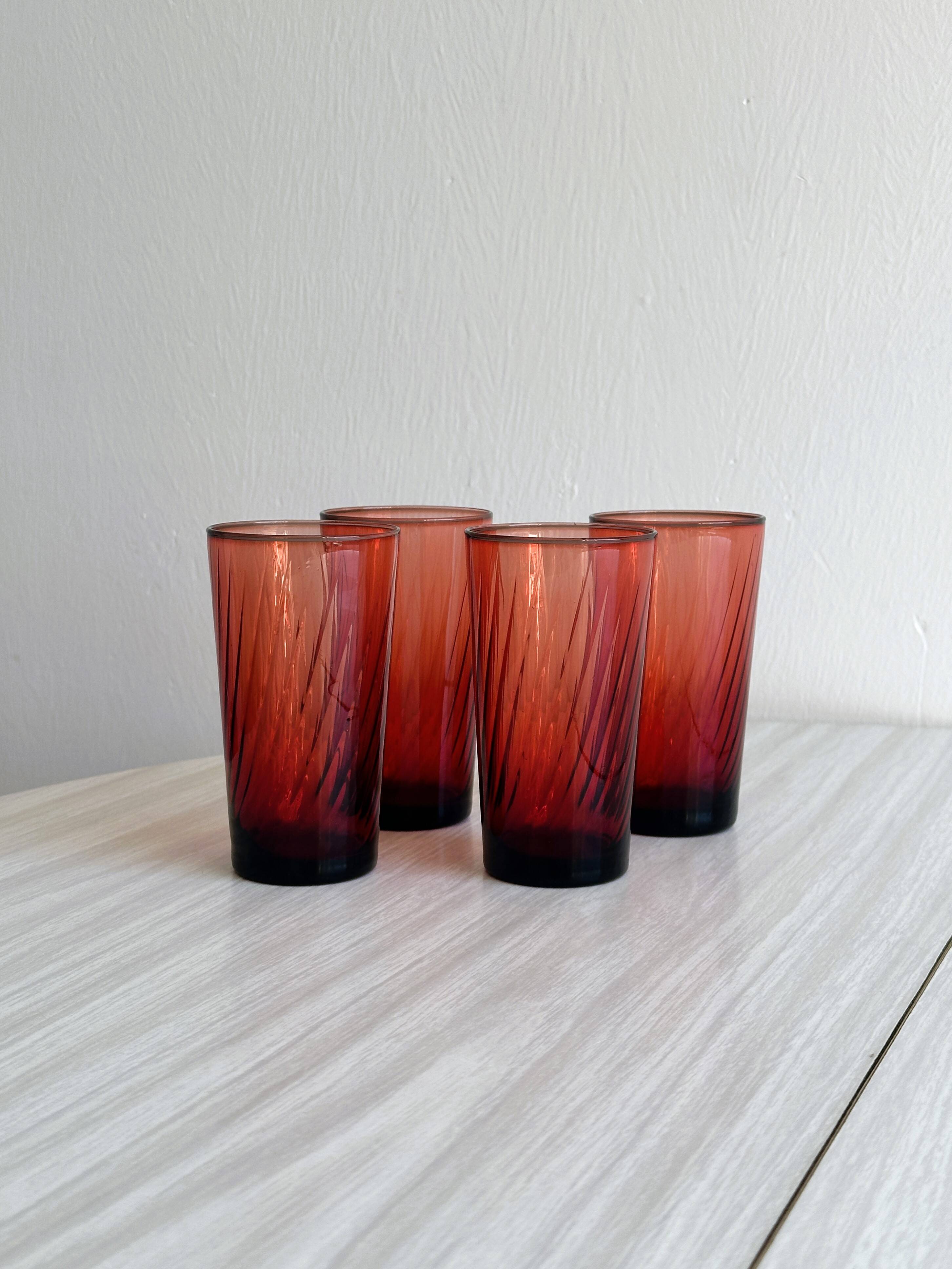4 verres à eau rouges translucides.