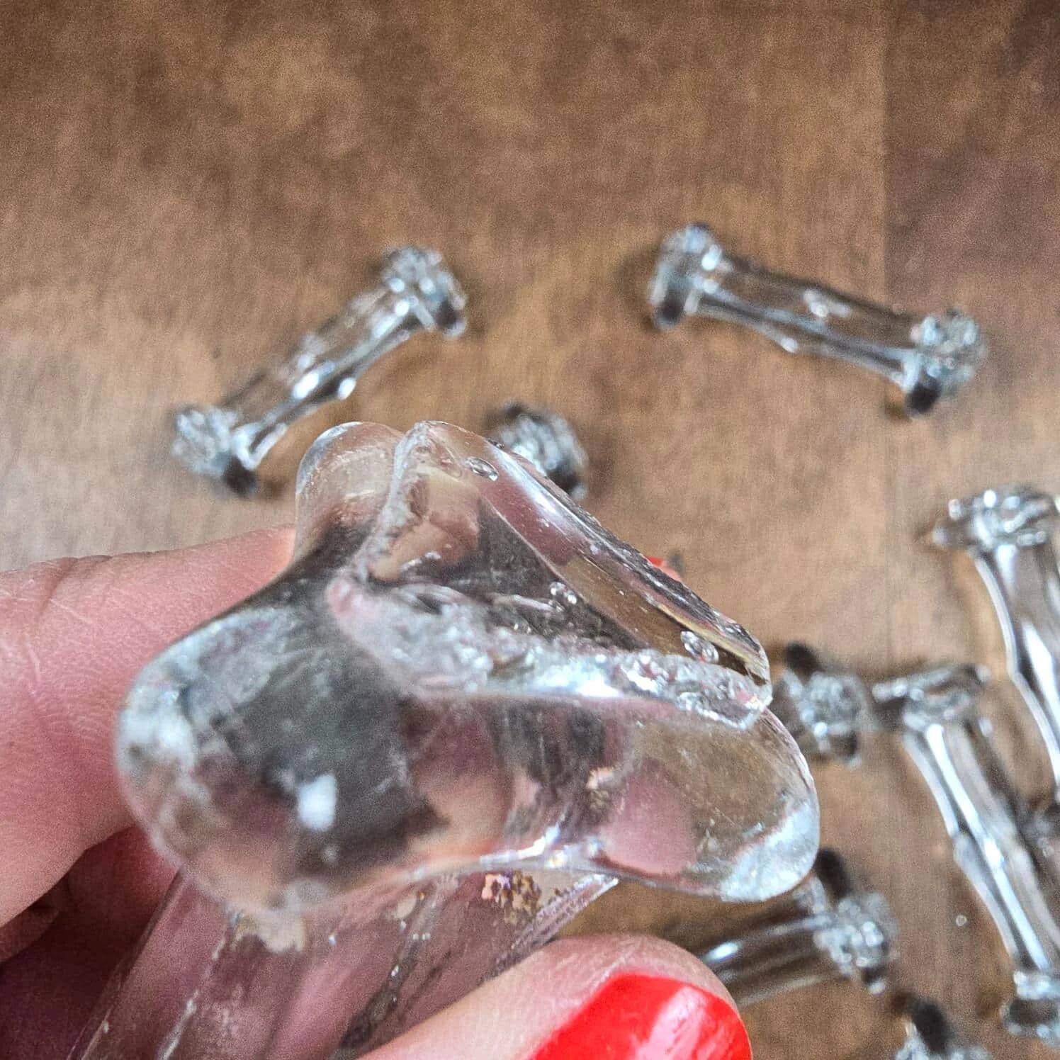 Set of 12 antique knife and fork rests in thick transparent glass.