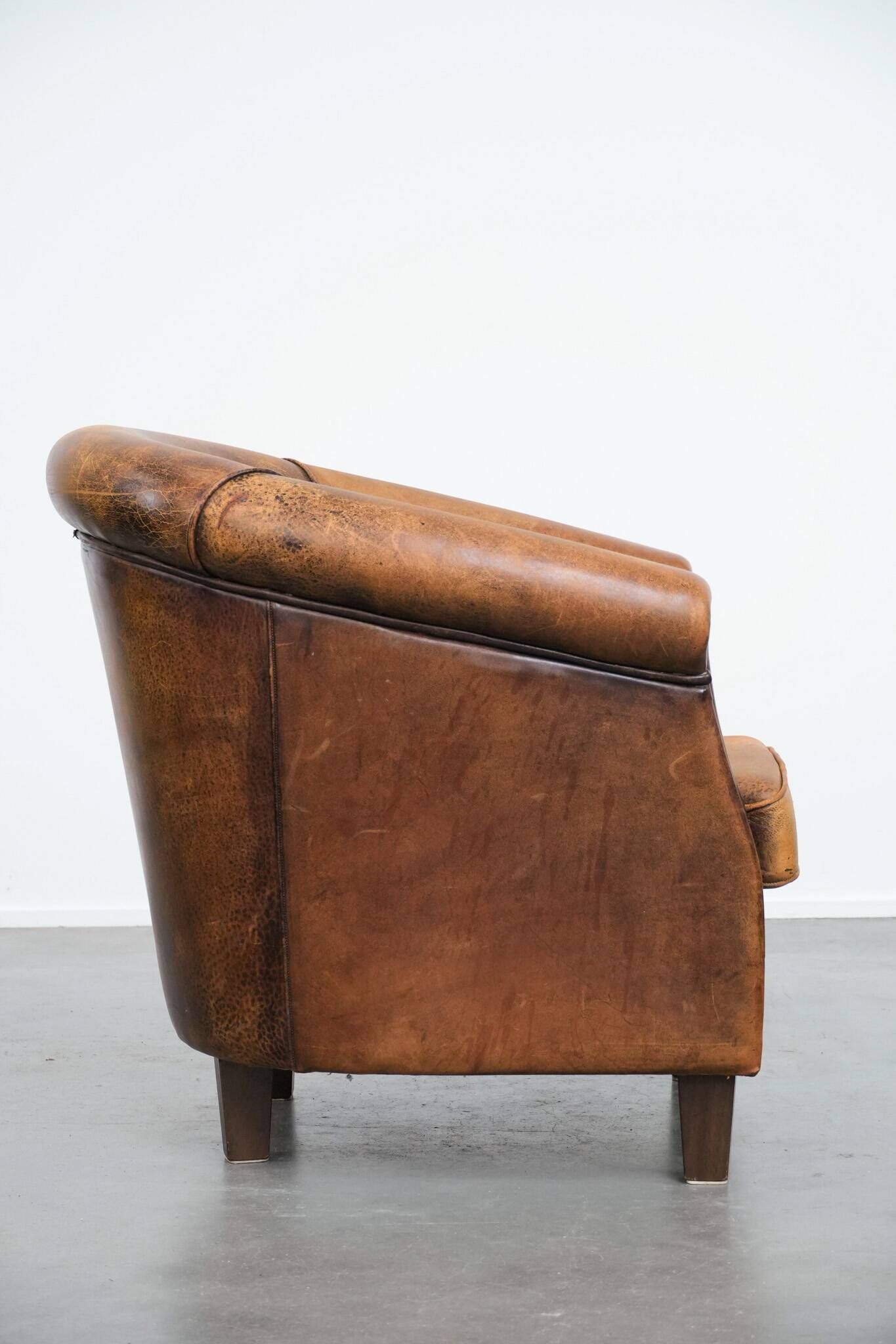 Vintage club chair in sheepskin leather with a characterful look