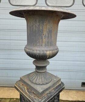 Large antique cast iron vases on pedestal