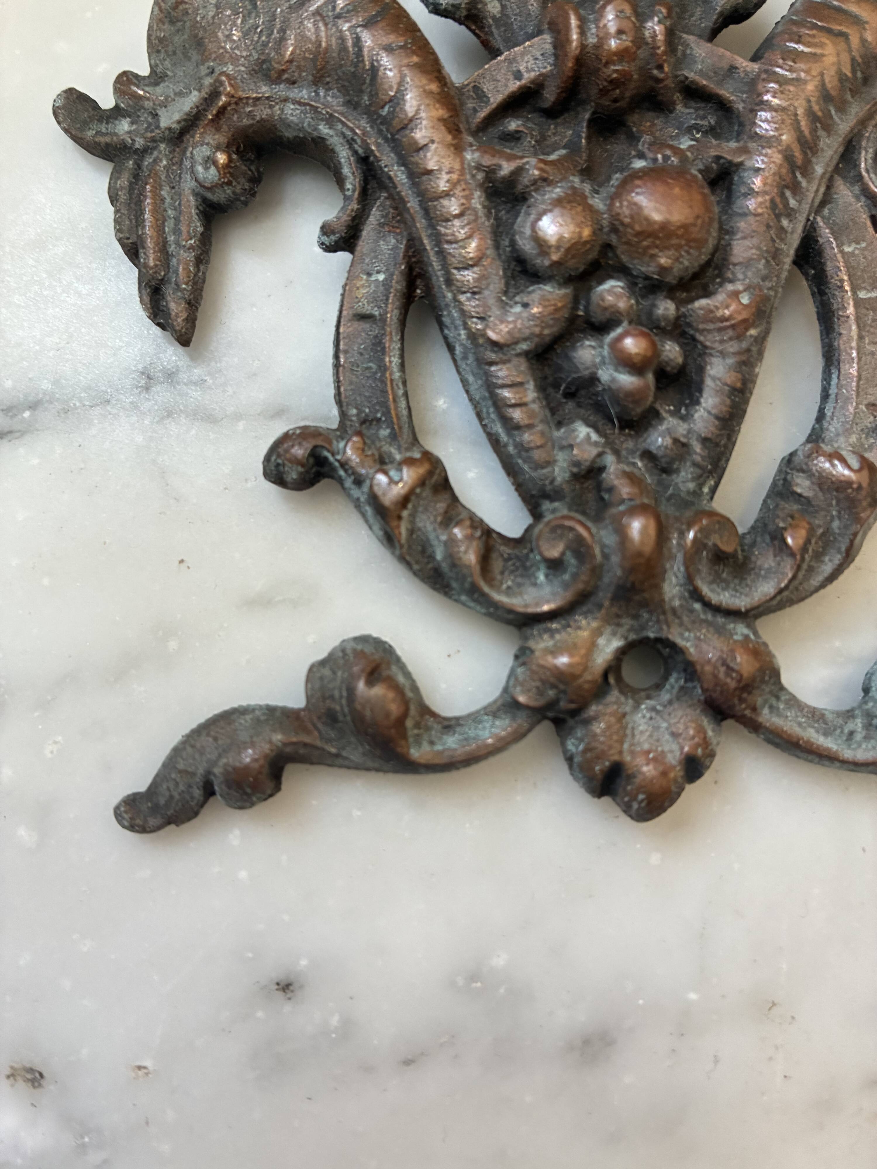 Vintage small furniture ornament in copper alloy with fish decoration.