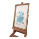 Decorative table with vintage blue flowers in a golden frame.