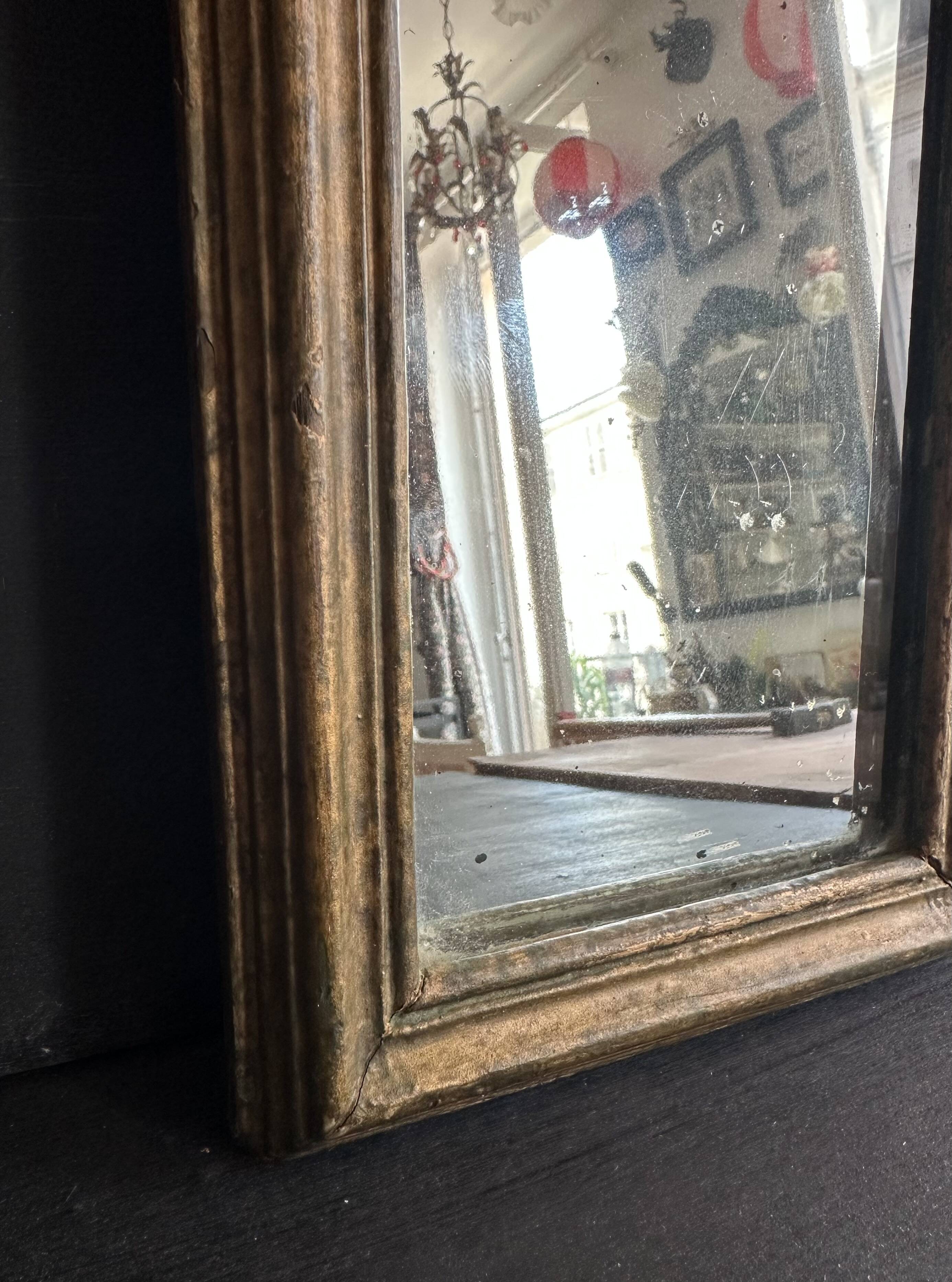 Miniature mirror from the 18th century in gilded wood, mercury glass.