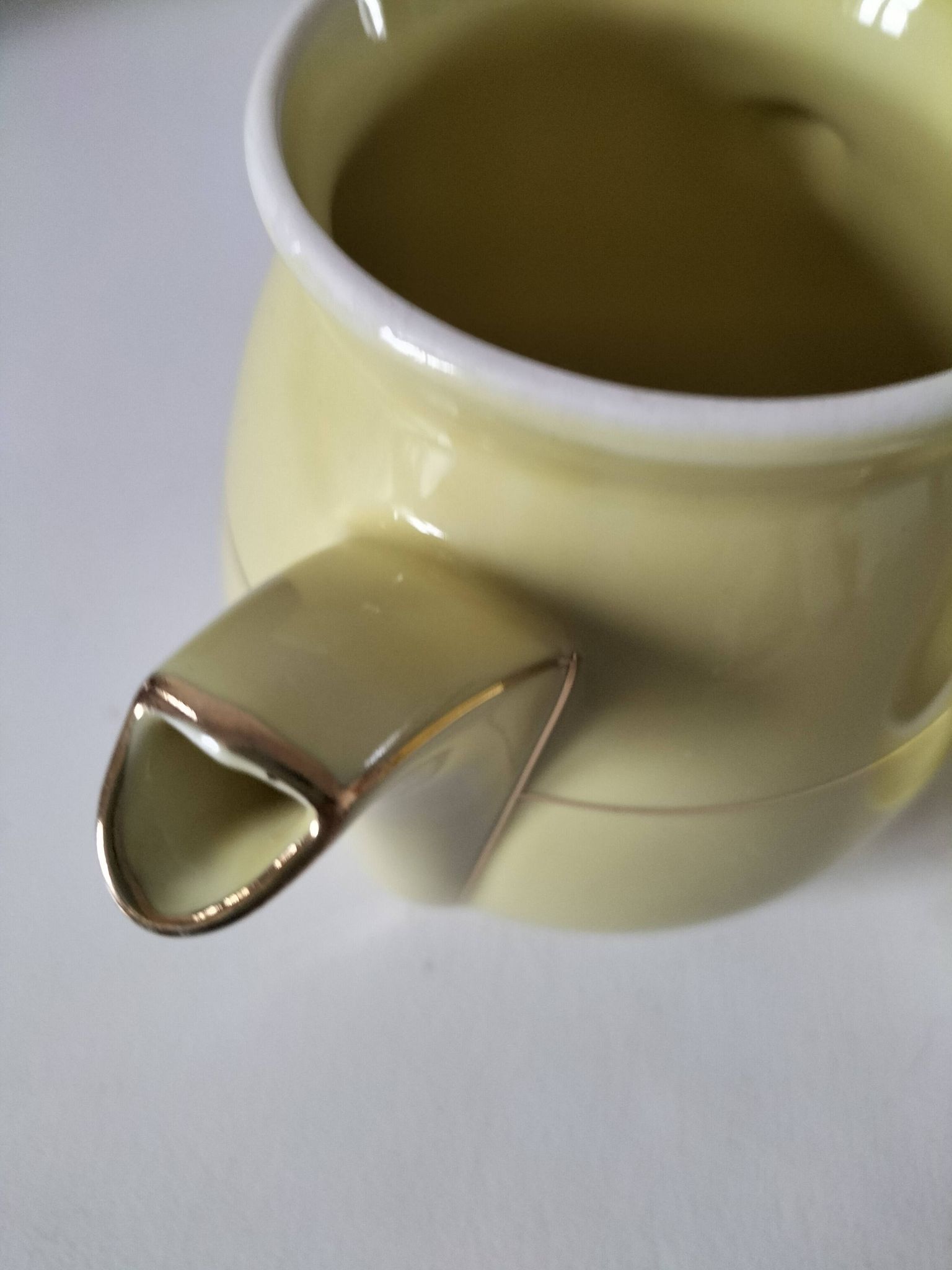 Vintage teapot in pastel yellow earthenware with gold trim