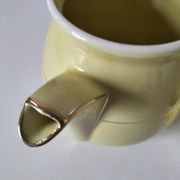 Vintage teapot in pastel yellow earthenware with gold trim
