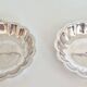 Silver-plated shell-shaped butter dishes, in the shape of a scallop shell.