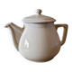 Vintage round ceramic teapot in cream colour, art deco style.