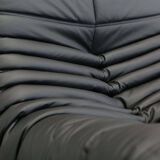 Togo armchair and footrest in black leather by Ligne Roset, designed by Michel Ducaroy.