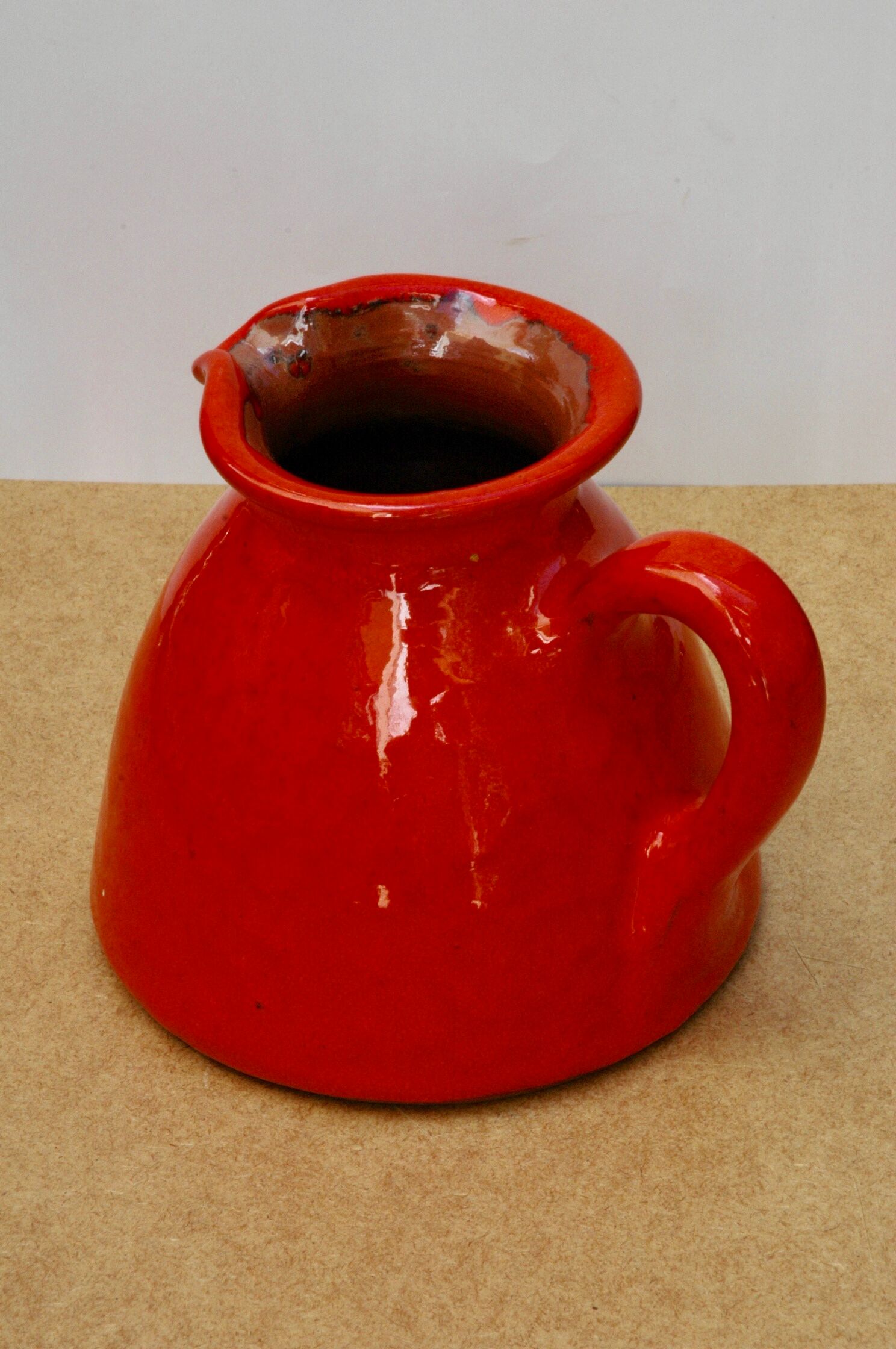 Orange earthen glazed pitcher
