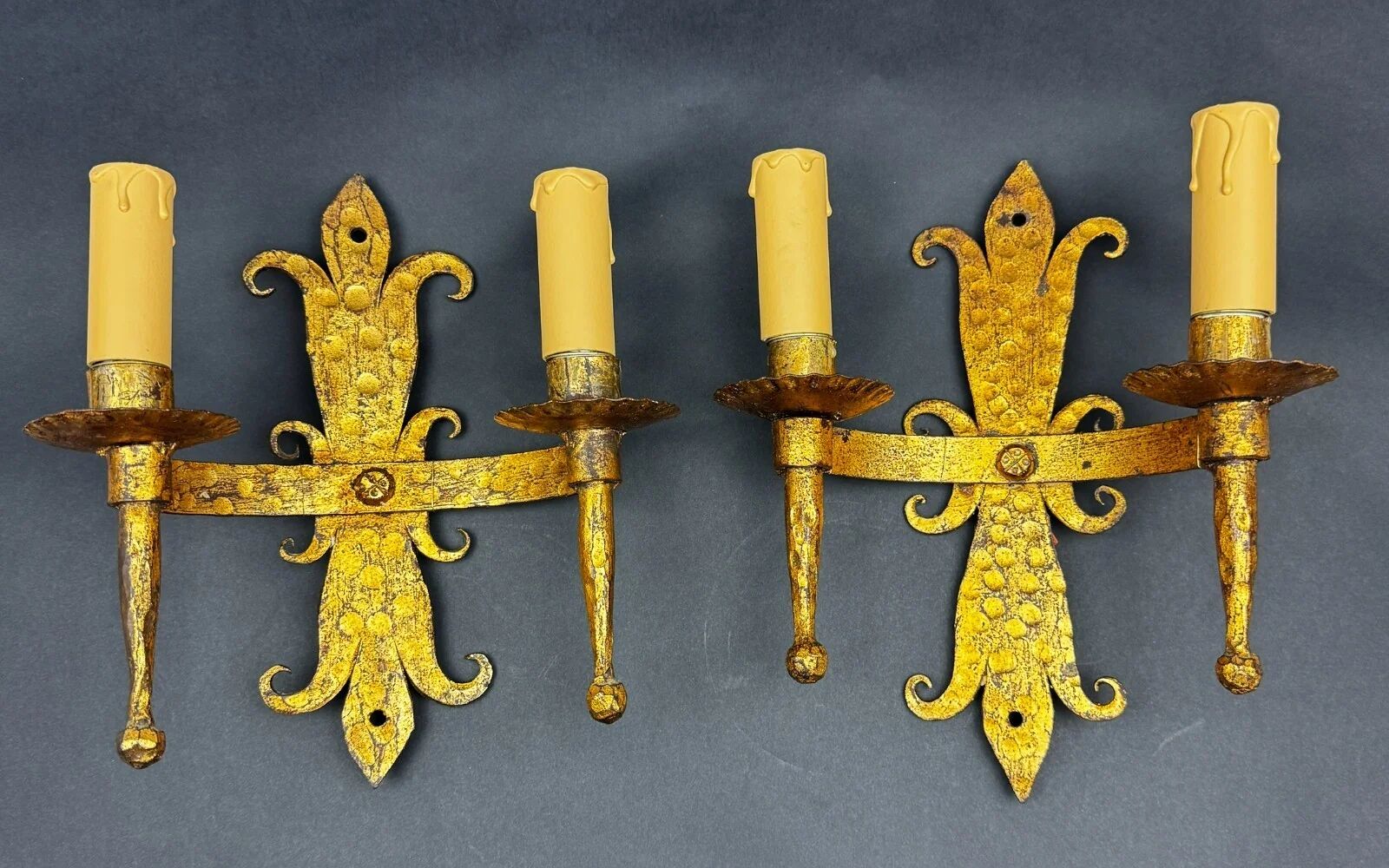 Pair of electrified golden wrought iron gothic wall sconces.