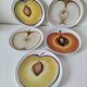 5 hand-painted dessert plates, decorated with stylised fruits.