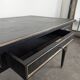 Large flat desk in Louis XVI style, black lacquered with gold highlights.