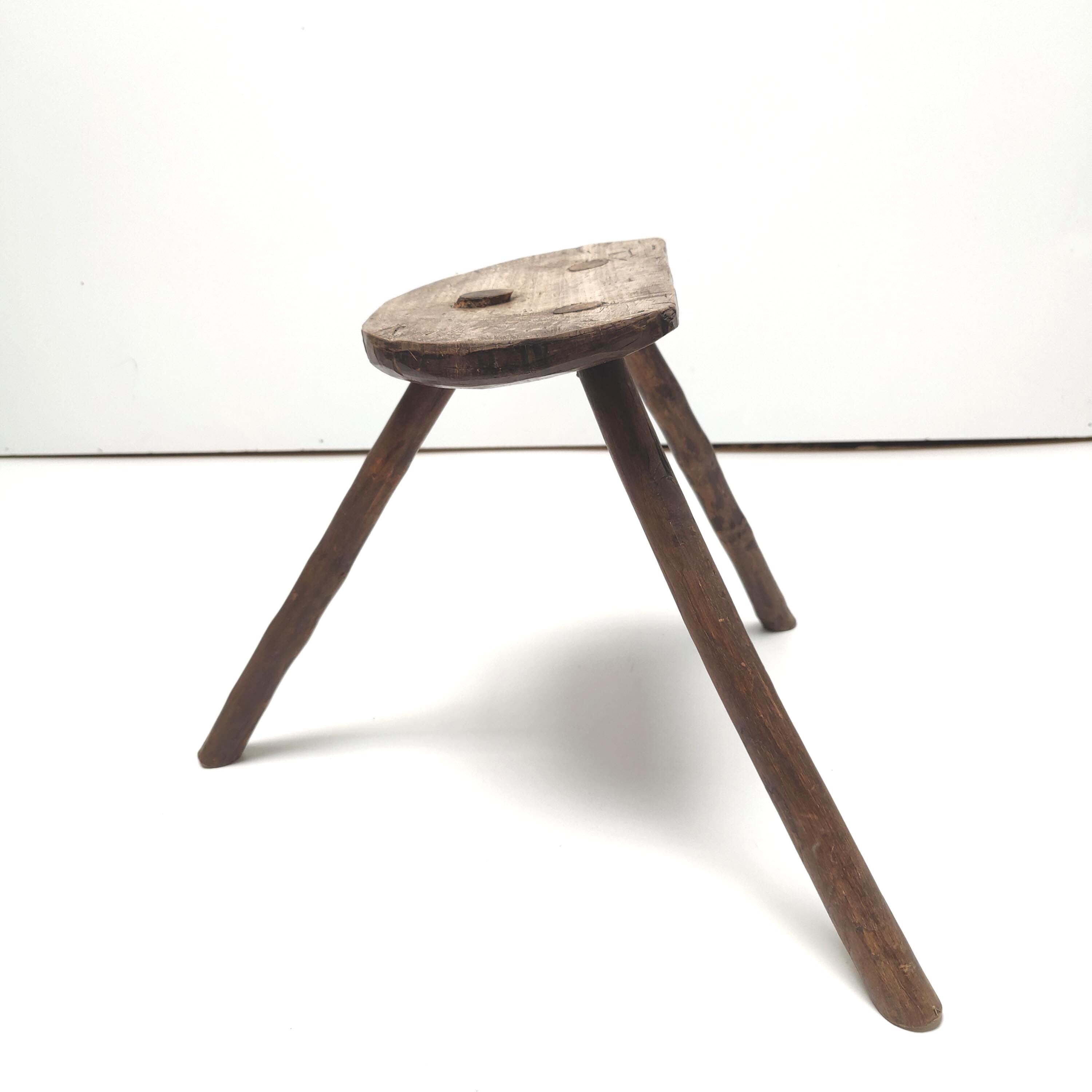 Brutalist tripod stool in solid wood half round