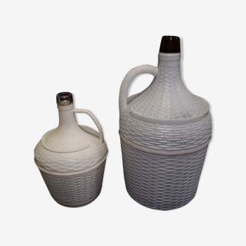 Pair of white covered demijohns