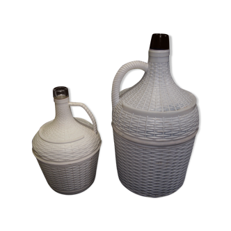 Pair of white covered demijohns