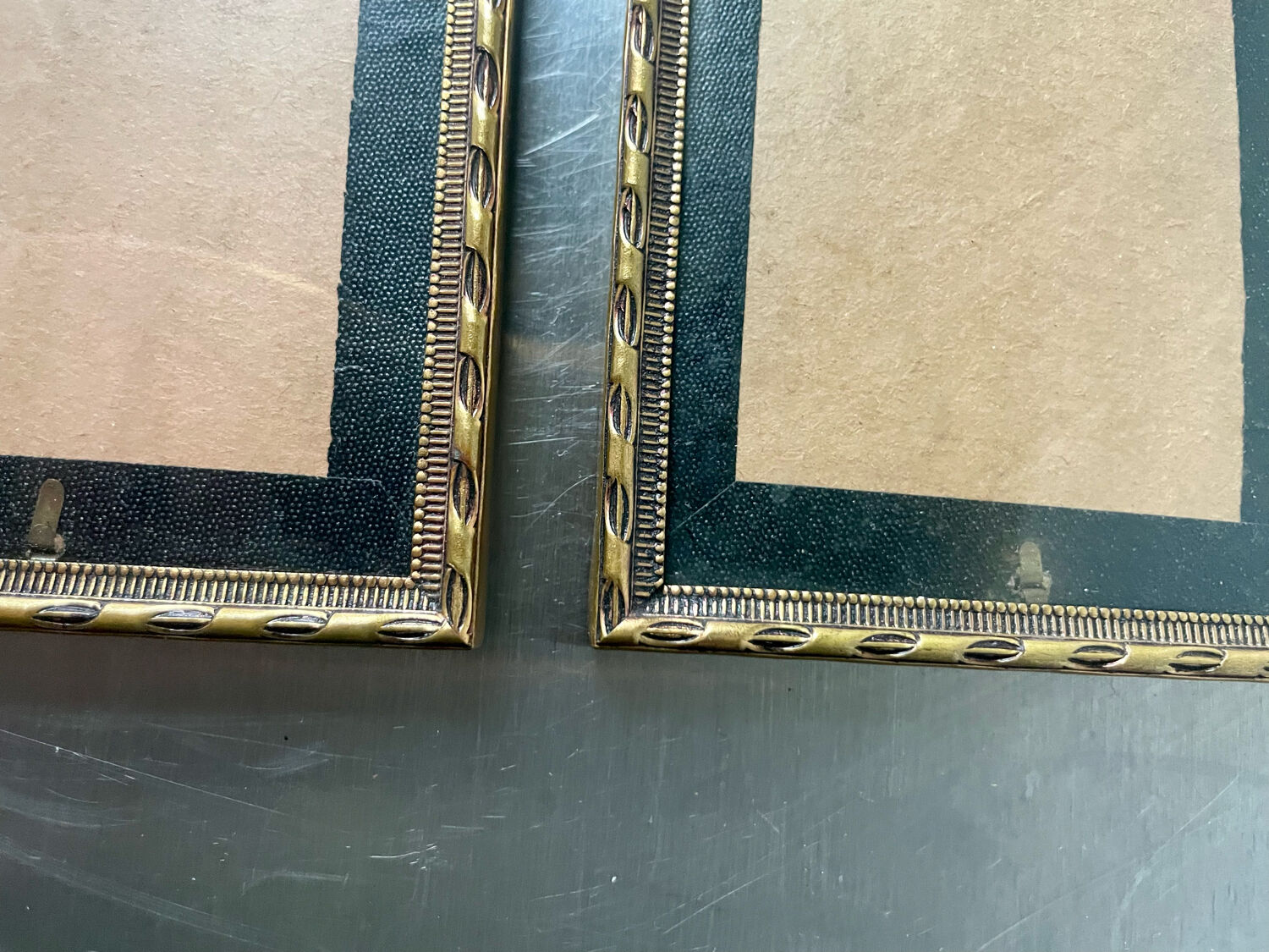 Pair of identical gold colored metal frames each measures  14.5 cm x 9 cm convex glass