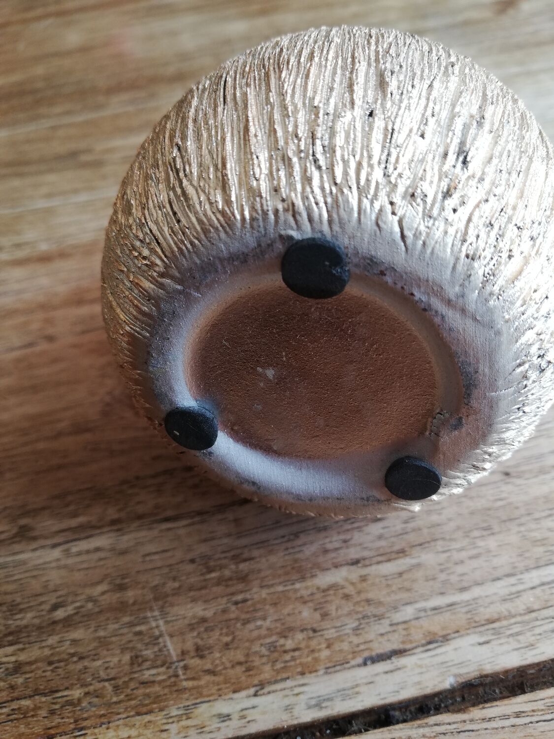 Small asymmetrical golden seed-shaped vase