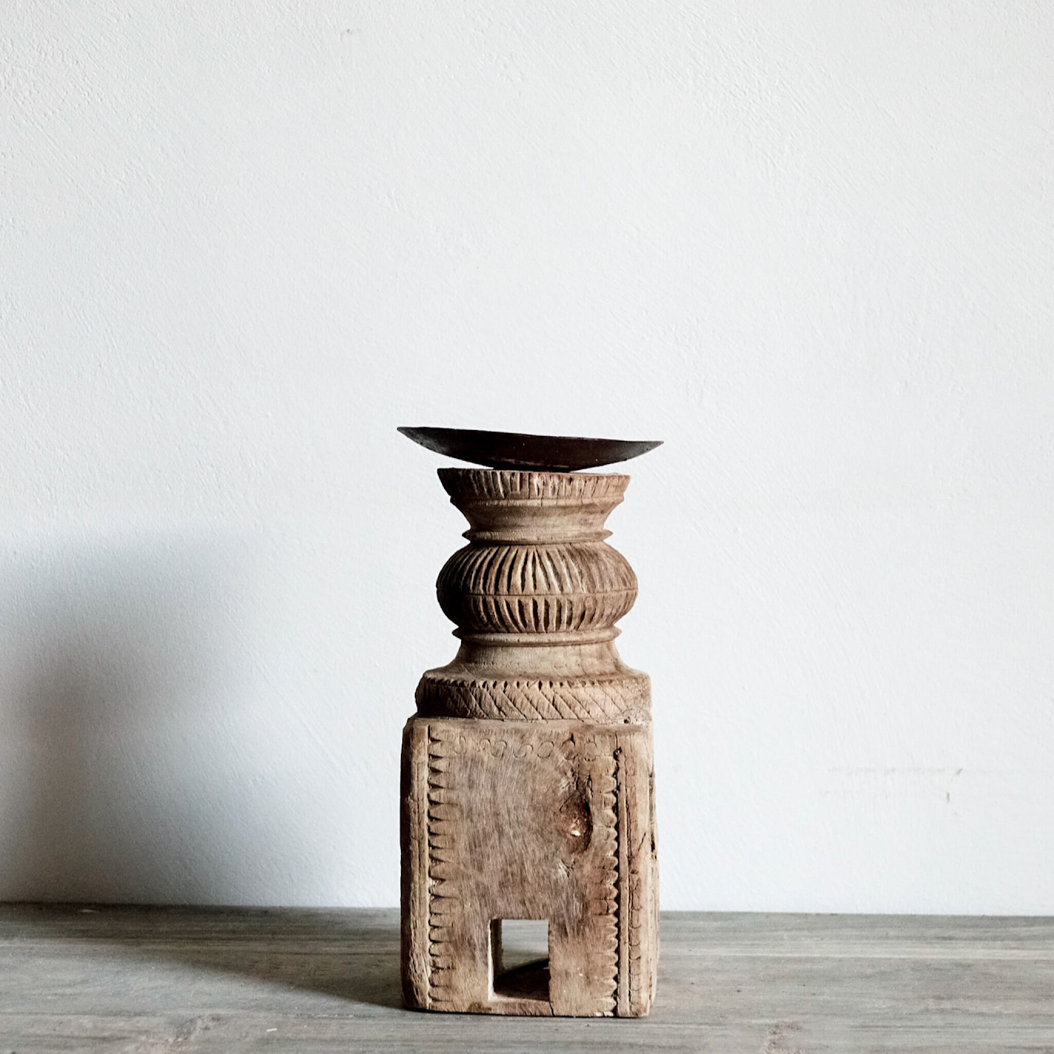 Candle holder in light carved wood