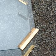 1970s designer coffee table in glass, plexiglass, and gold metal.