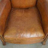 Beautiful and comfortable sheepskin armchair, finished with decorative nailheads