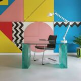 Solid glass desk with a half-moon top.