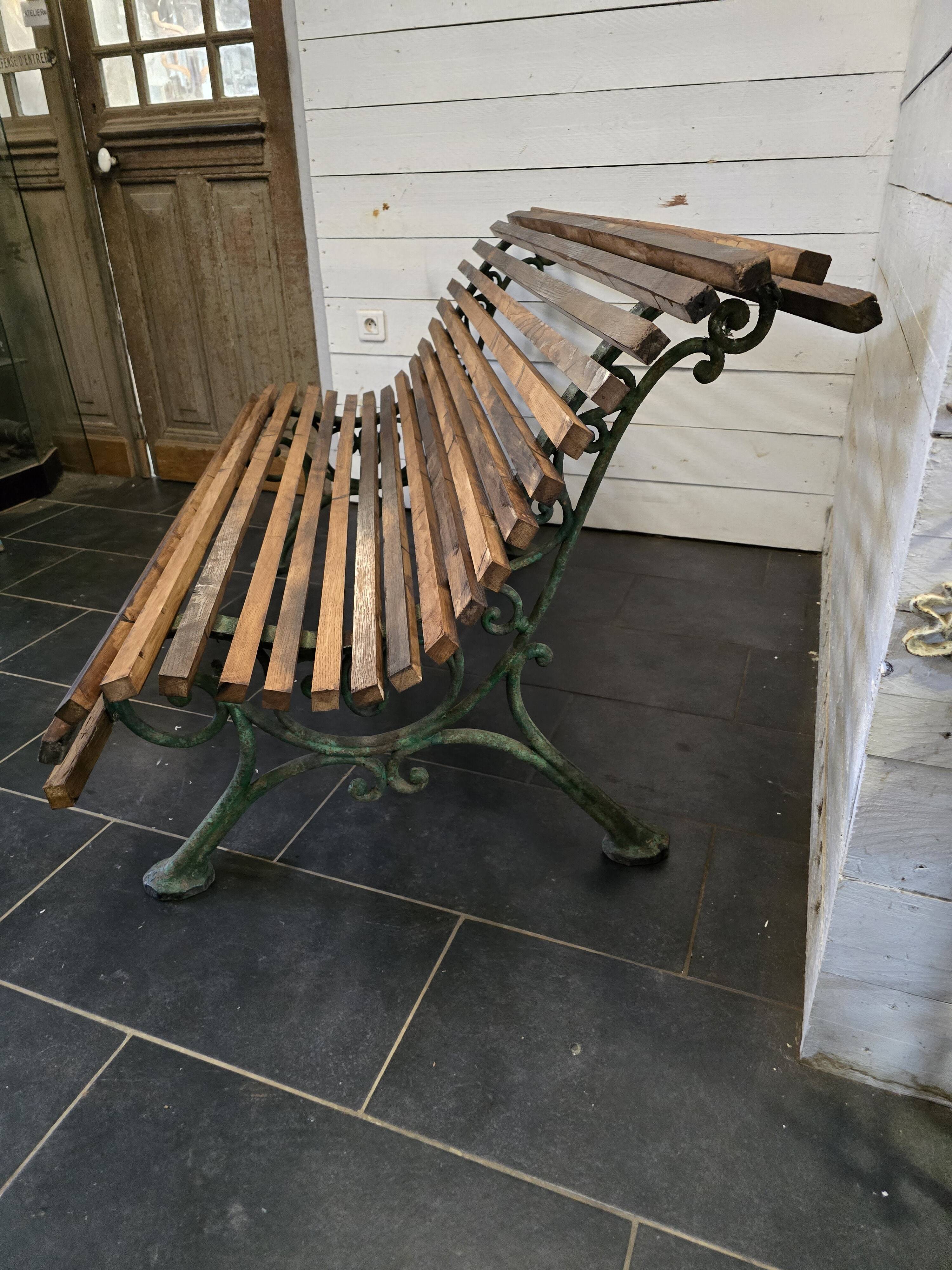 Old cast iron garden bench with oak slats