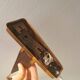 Wall lamp with adjustable ‘arm’ in copper and rosewood, with white shade.