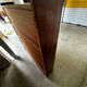 Vintage 1960s wooden library with sliding doors.