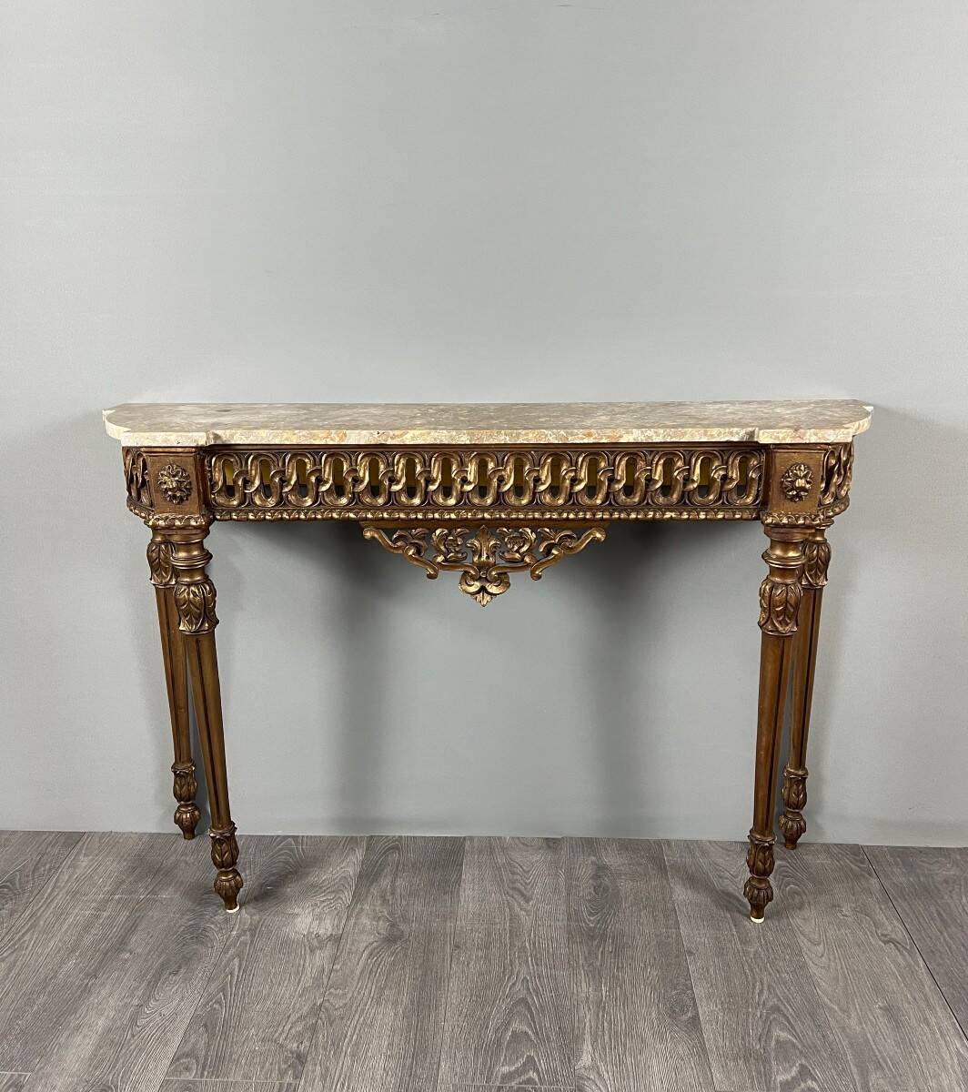 Louis XVI style console in carved wood with a gilded patina, 19th century.