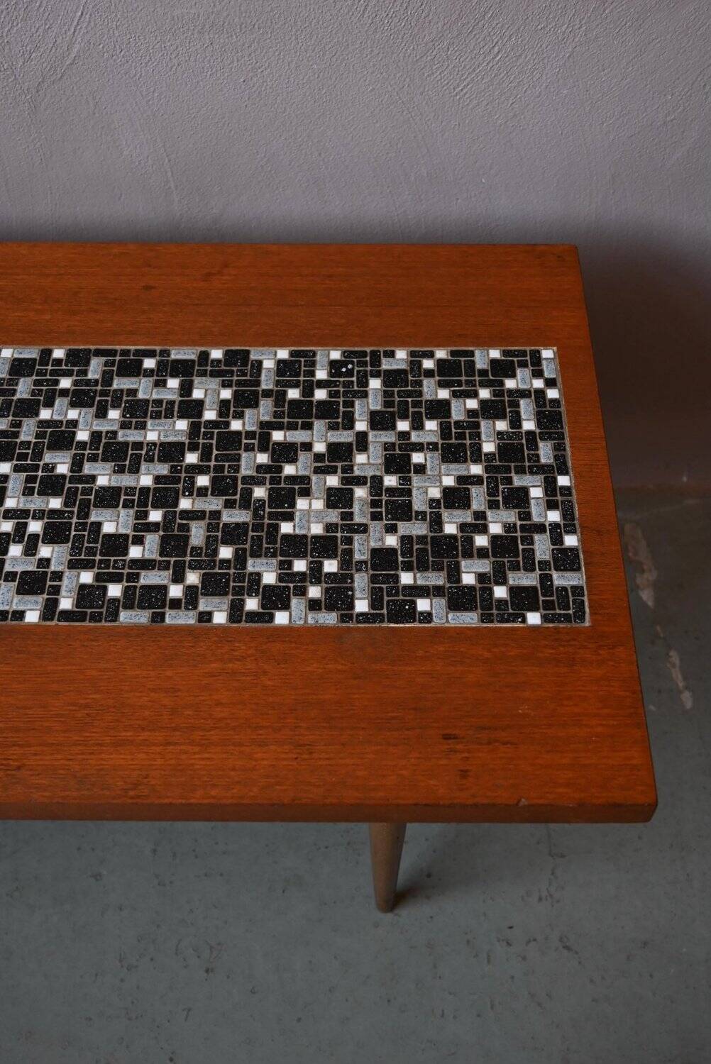 1970s coffee table with a tapered teak base and ceramic mosaic.