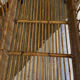 Vintage rattan baby cot on wheels.