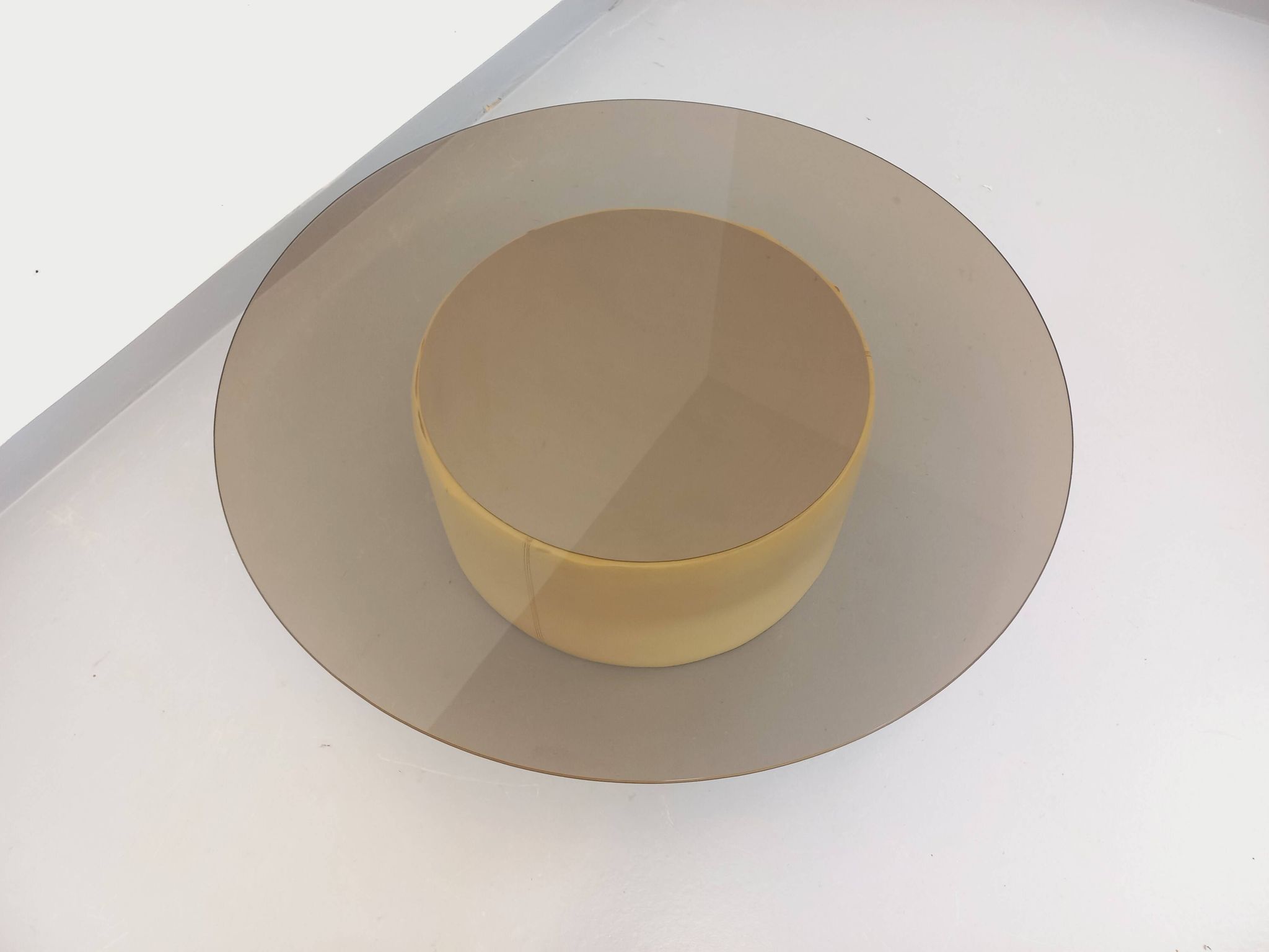 Vintage round coffee table in glass, leather, and metal in Space Age style from the 70s.