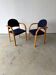 Set of two stackable beech chairs in curved Scandinavian style from IKEA.