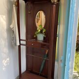 Antique wooden coat rack with mirror and shelf.