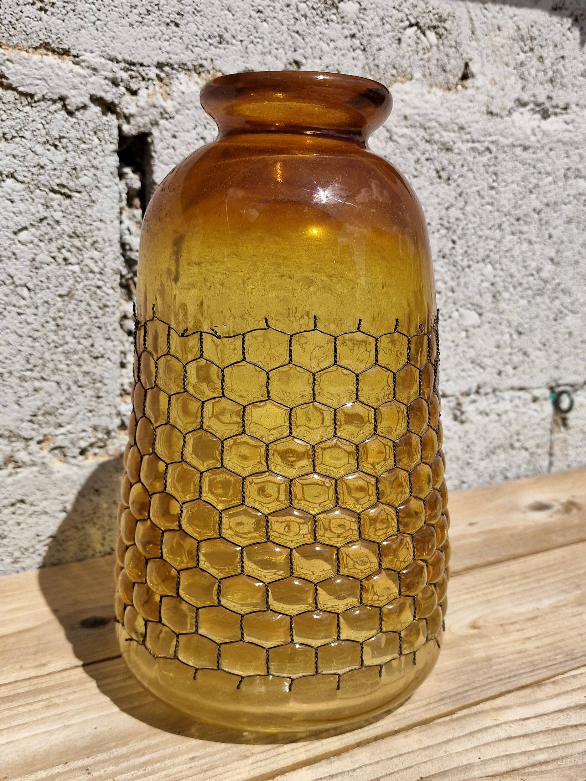 Artisanal blown amber glass vase with integrated honeycomb structure.