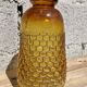 Artisanal blown amber glass vase with integrated honeycomb structure.