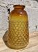 Artisanal blown amber glass vase with integrated honeycomb structure.