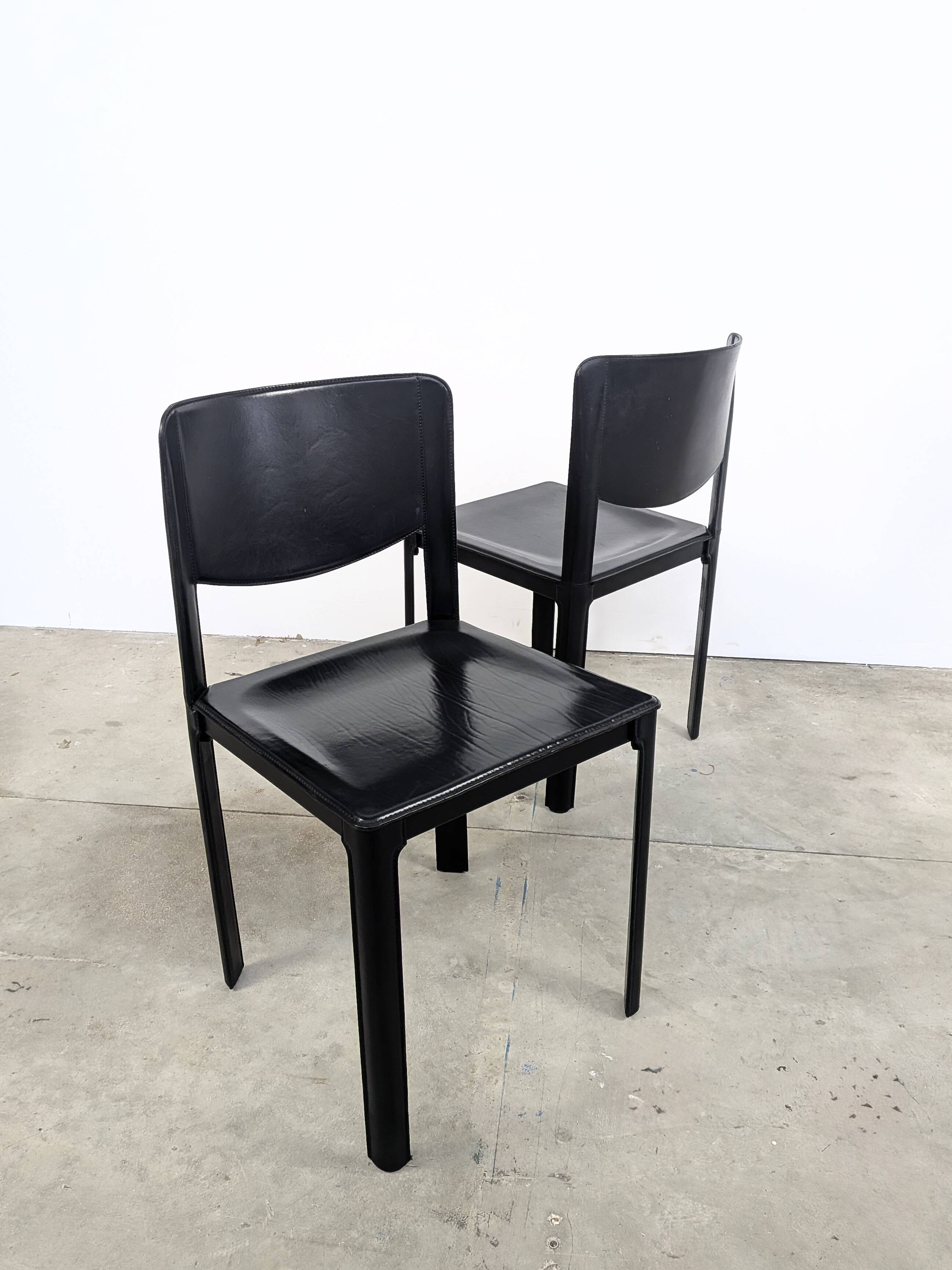 Pair of Matteo Grassi chairs in black saddle leather, 1980s.