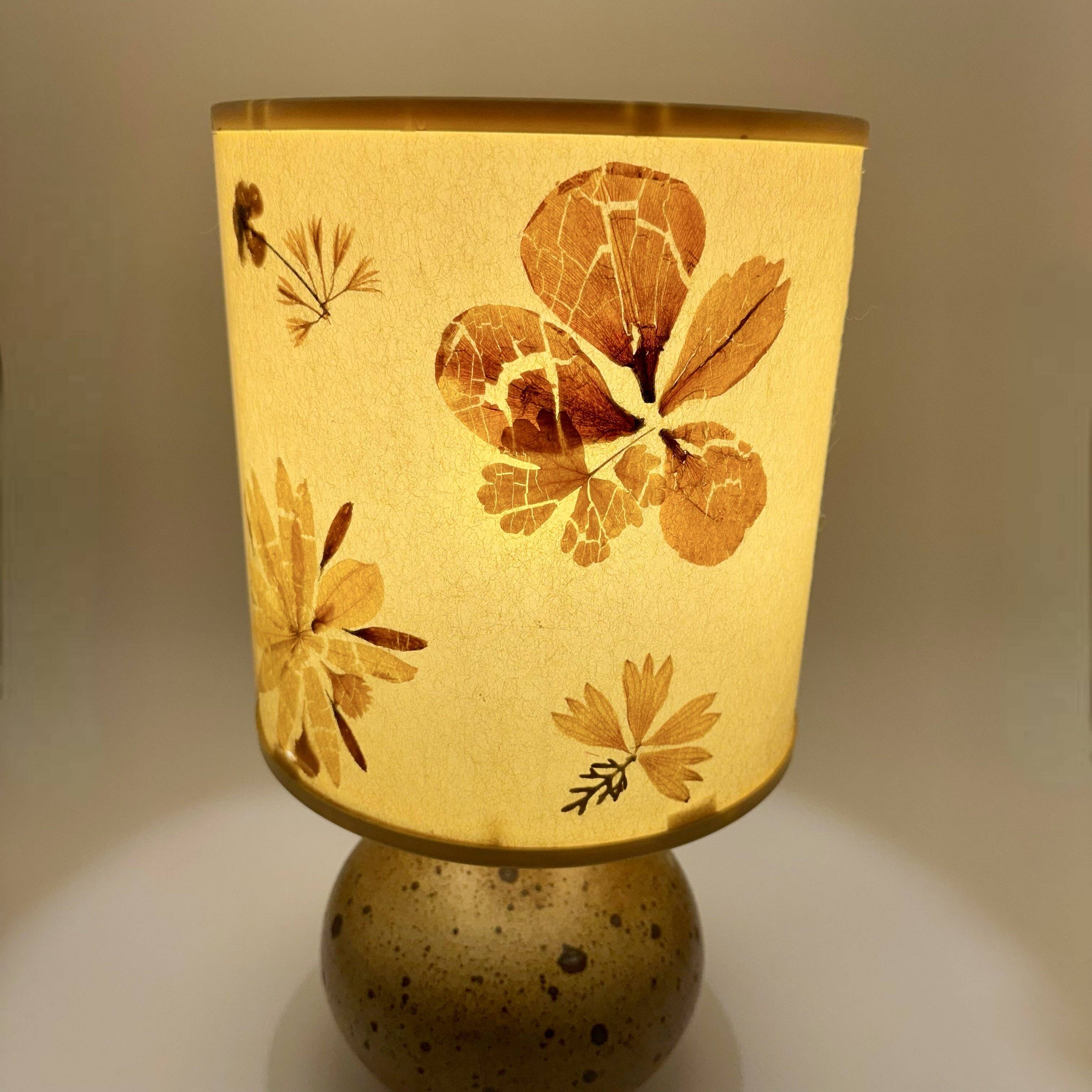 Pyrite stone ball lamp with a lampshade featuring dried flower inclusions.