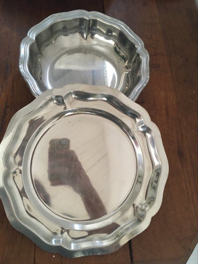 Two matching round dishes in stainless steel