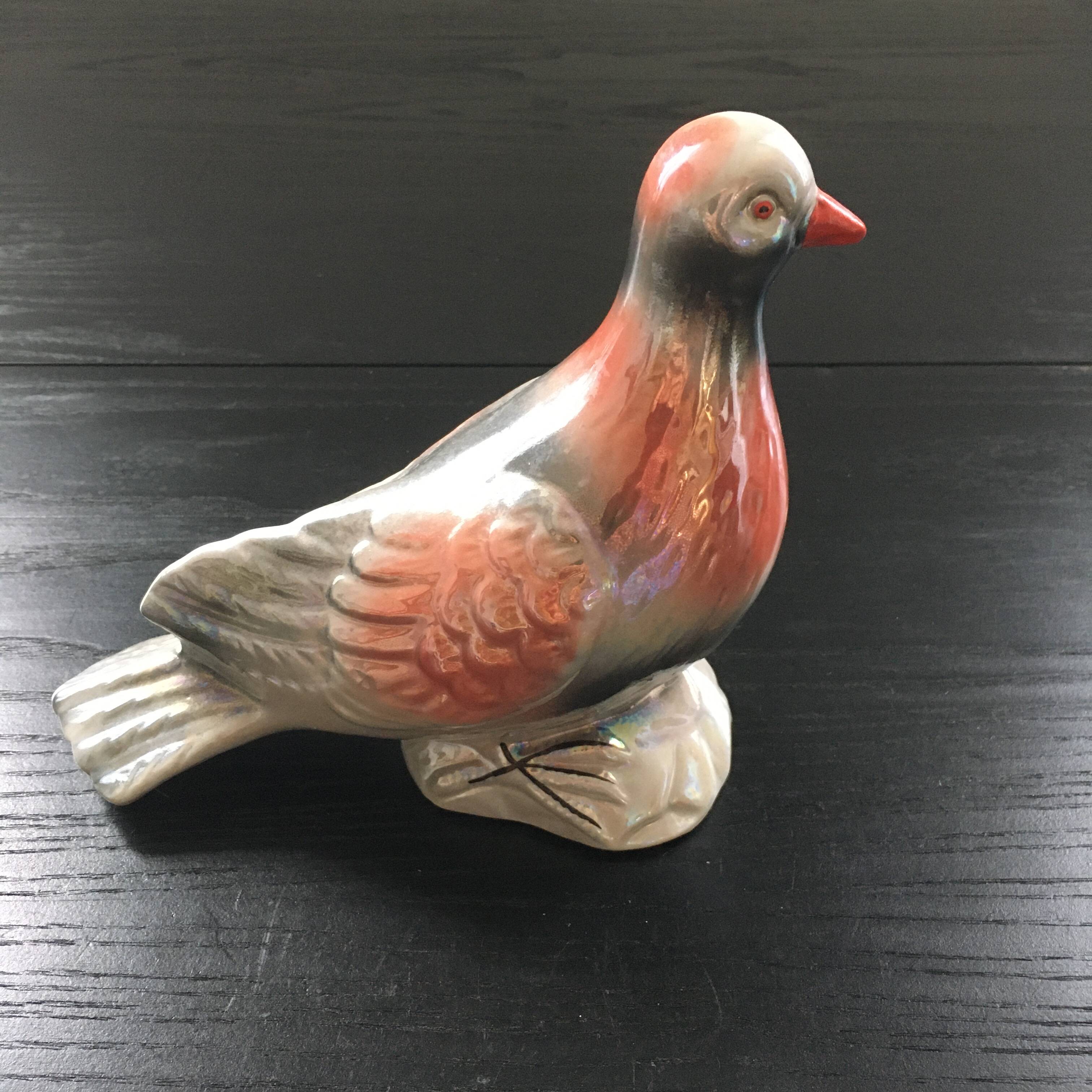 Antique bird in pearly ceramic