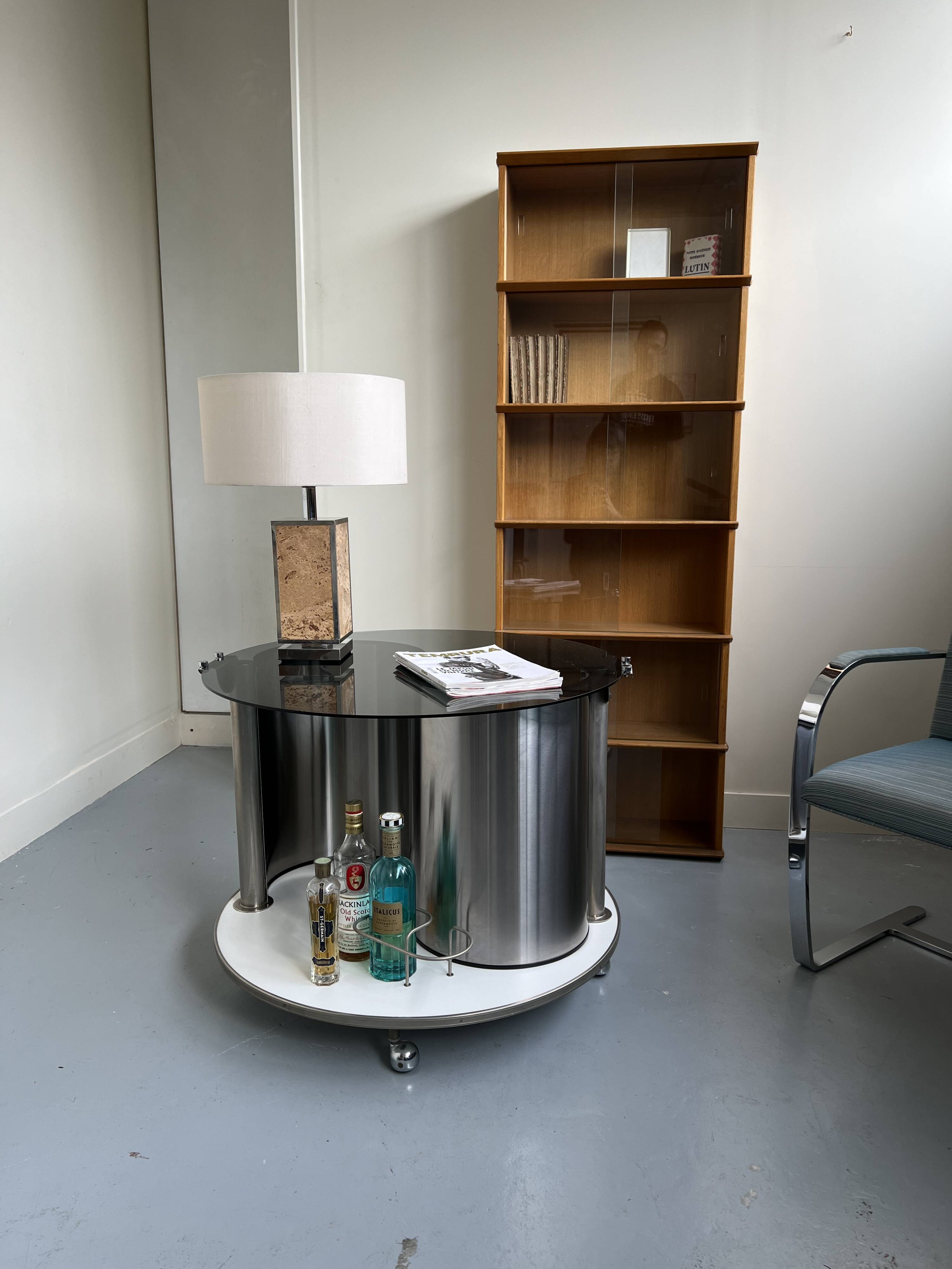 Vintage metal and smoked glass coffee table on casters bar