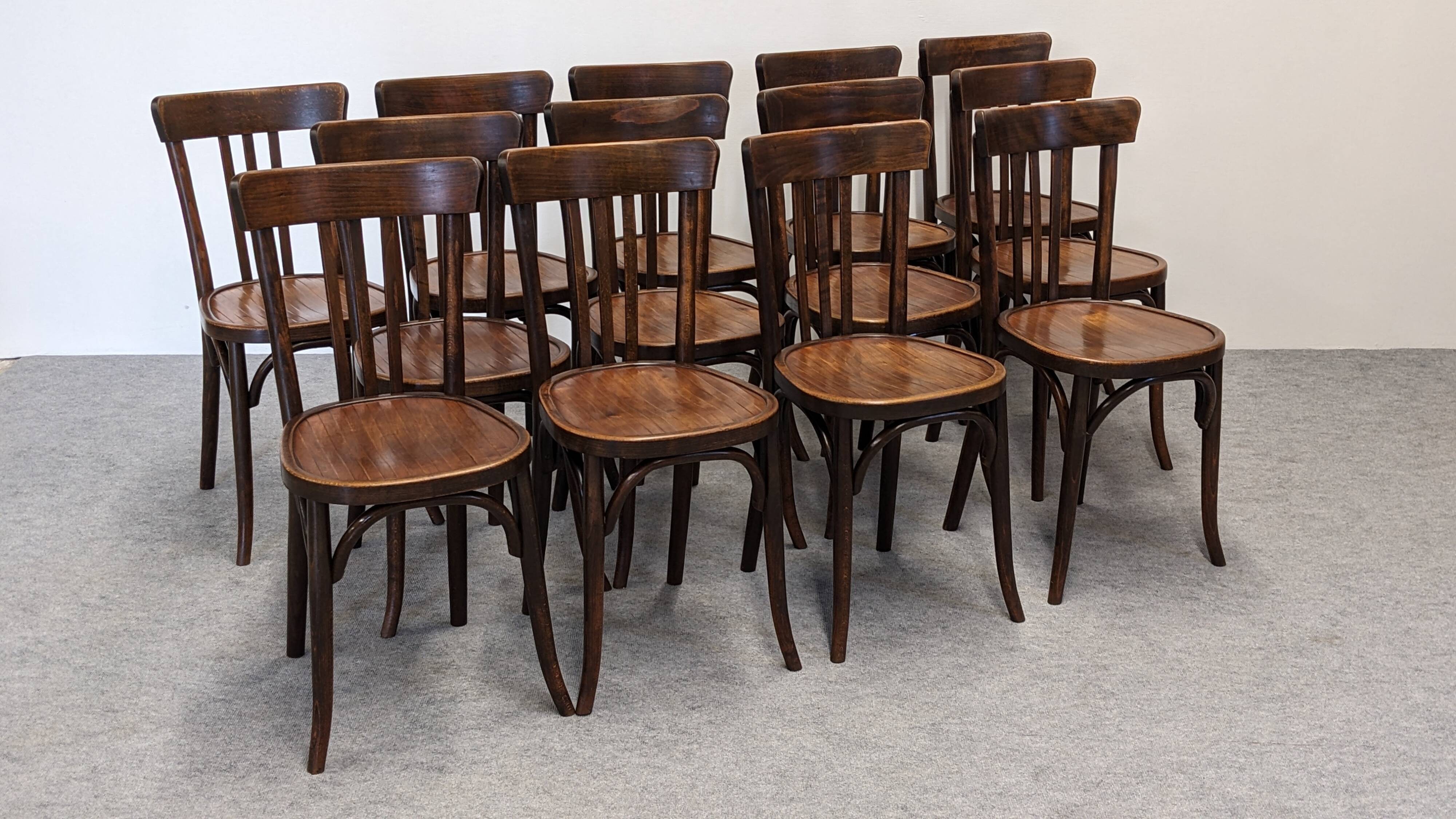Set of 13 Baumann bistro chairs in bent beech, France circa 1930.