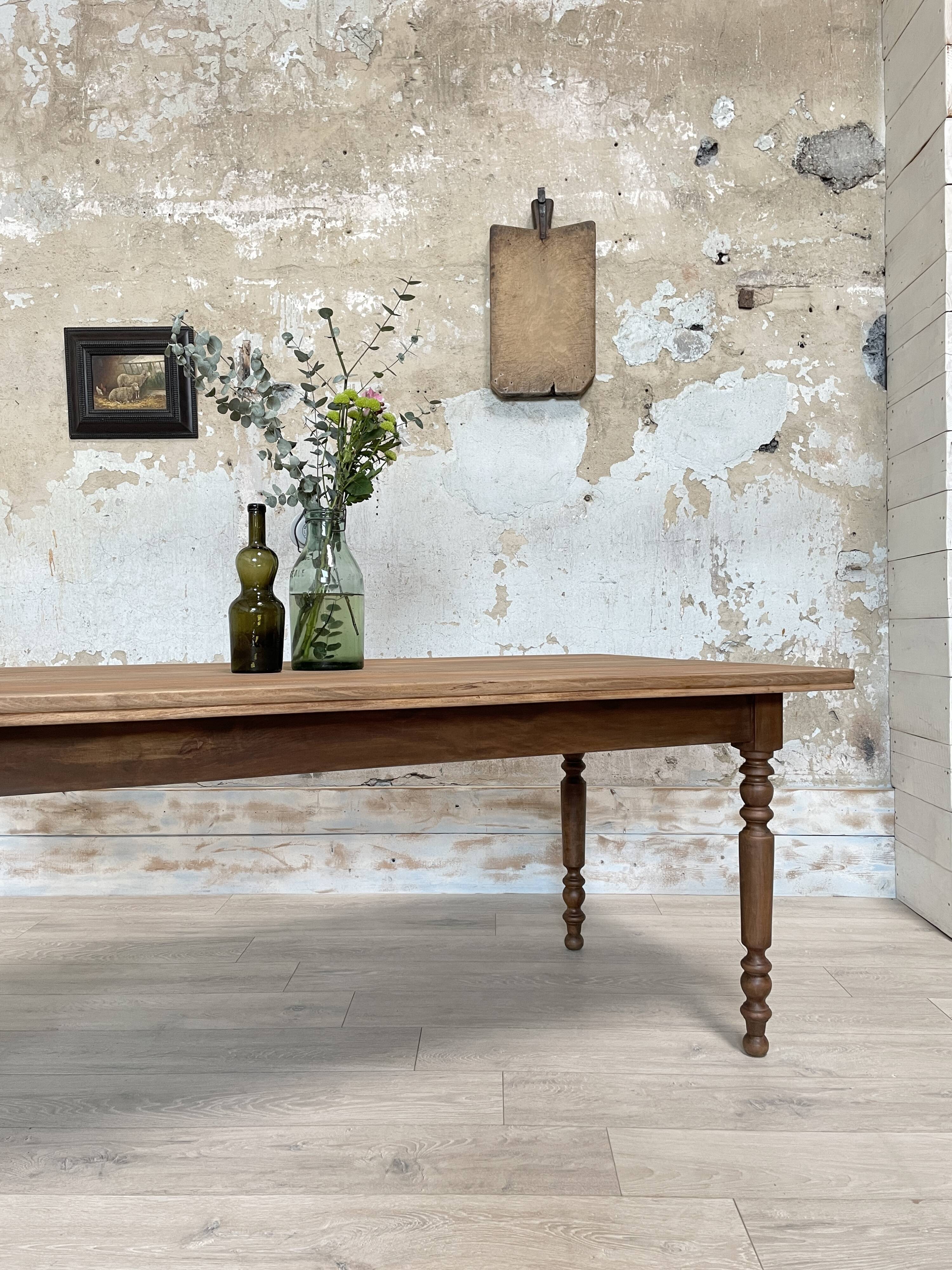 Vintage farmhouse table with turned legs.